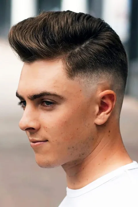 Quiff alto con taper fade, vista de perfil